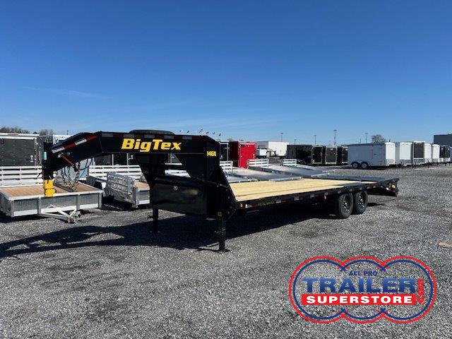 a big tex trailer is parked in a gravel lot .