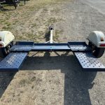 a master tow trailer parked on the side of a dirt road .