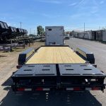 a CAM Superline flatbed trailer parked on the side of a road