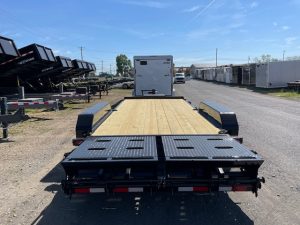 a CAM Superline flatbed trailer parked on the side of a road