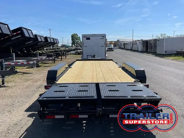 a CAM Superline flatbed trailer parked on the side of a road